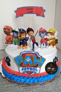 a birthday cake with paw patrol figures on it