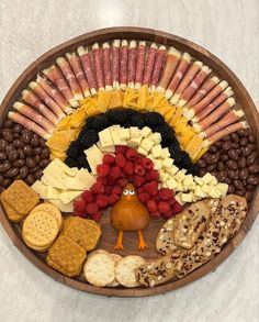 a turkey shaped platter filled with crackers, cheeses, and other snacks