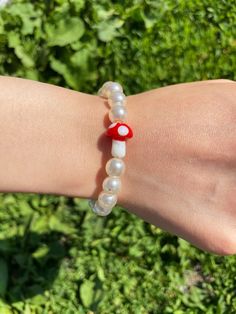 "the mushroom dummie consists of a cute mushroom bead in the centre, surrounded by pearls! can be an anklet or a bracelet :) for more go to https://www.dummiezshop.com or @dummiezshop on instagram :)  dimensions: bracelet  -- 6\" anklet -- 9\"" Mushroom Bead Bracelet, Fairycore Bracelet Ideas, Mushroom Bead Ring, Mushroom Beaded Necklace, Y2k Beaded Necklace, Instagram Dimensions, Mushroom Necklace Bead, Mushroom Beads, Homemade Bracelets