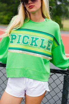 Score a style slam dunk with our Designated Dinker Pickleball Pullover! This playful cropped pullover features a vibrant green striped ribbon and green terry PICKLE lettering. Perfect for adding a touch of fun to your athletic wardrobe. All orders are currently shipping within 14 business days. To receive item quicker, expedited shipping is available at checkout. Shirt Prints, Cropped Pullover, Striped Ribbon, Slam Dunk, Vibrant Green, A Style, Pickleball, Green Stripes, Tshirt Print