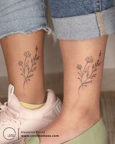 two people with matching tattoos on their legs, one has a plant and the other has a