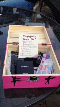 an empty pink trunk sitting on top of a glass table next to a sign that says emergency