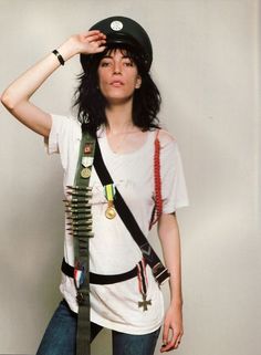 a woman in white shirt and black helmet holding up her hat with two ties on it