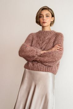 "The Chunky Braid Sweater -- a chunky yet lightweight raglan sweater featuring a braid cable stitch and an extra chunky ribbed neck. Hand knit with warm, super soft and luxurious kid mohair that feels like being wrapped inside a squishy, puffy cloud. Designed to flatter all silhouettes with its wide boxy fit, slightly cropped body and wrist-exposing voluminous balloon sleeves. Made to order in 4 colorways with a subtle melange feel. Handcrafted in Greece. DETAILS * Super soft, premium quality It Cable Sweaters, Chunky Braids, Gamine Style, Soft Gamine, Raglan Sweater, Cropped Pullover, Cable Stitch, Knit Crop Top, Chunky Sweater