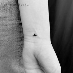 a small crown tattoo on the wrist