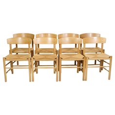 six wooden chairs sitting next to each other