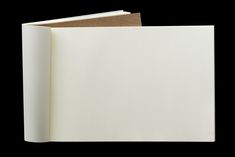 an open white book on a black background