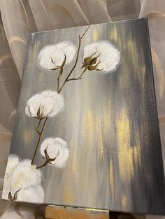 a painting with white flowers painted on it