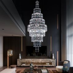 a living room filled with furniture and a large chandelier hanging from the ceiling