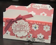 a pink and white birthday card sitting on top of a table