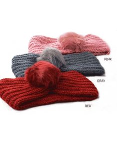 three different colors of knitted mittens with pom - poms