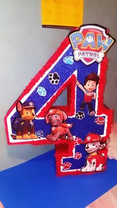 a birthday cake with the number four in it's center and paw patrol characters