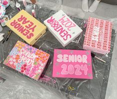 some pink and yellow books on a table