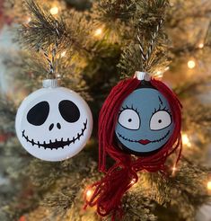 two ornaments hanging from a christmas tree decorated like jack skellingy and jack - o'lantern