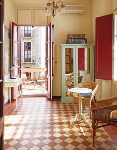 an open door leading into a room with red and white checkered flooring on the walls