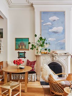 a living room filled with furniture and a fire place under a painting on the wall