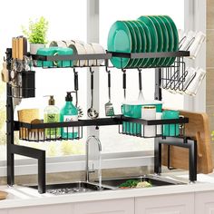 the dish rack is filled with dishes and utensils in green, black, and white