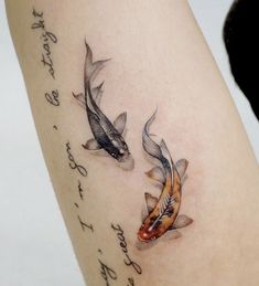 two koi fish on the arm with words written in cursive writing below them