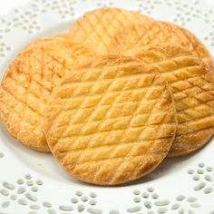 three cookies sitting on top of a white plate