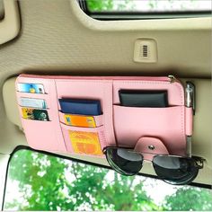 a pink wallet with sunglasses hanging from it