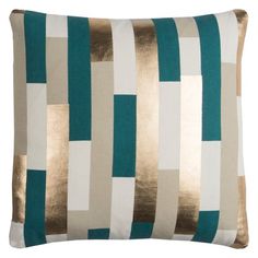 a green and white pillow with gold foil on the front, along with an aqua blue stripe