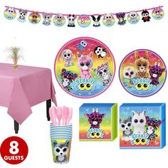 a party set up with pink table cloths, plates and napkins for an animal themed birthday