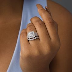 a woman's hand with a diamond ring on it