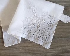 10% Off 2 or More Code SAVE10 Vintage Wedding Handkerchief ~ This all white hankie features floral Madeira style embroidery and fancy drawn-thread details on one corner.  There are tiny flowers on each of the other corners. The white satin embroidery is exceptional. It is made of  soft cotton and has a hand-rolled hem. A perfect 'something old' something beautiful for the bride!  Measures 12 x 12 inches Thanks for visiting → RoseAnaDana.Etsy.com . Elegant White Handkerchiefs With Floral Embroidery, Elegant White Floral Embroidered Handkerchiefs, Classic White Embroidered Handkerchiefs, Formal White Embroidered Handkerchiefs, Elegant White Handkerchiefs With Machine Embroidery, Traditional White Handkerchiefs With Floral Embroidery, Satin Embroidery, Embroidery Vintage, Drawn Thread