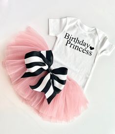 This full tutu has ten layers with a wide elastic band inside to keep the itchy tulle off your little ones' skin. The multiple soft layers give a fluffy look but lays perfectly. The bow can clip onto the tutu for your desired look. OPTIONS AVAILABLE FOR PURCHASE: Bodysuit/ Shirt Tutu with removable bow Crown Tutus are perfect for birthdays, weddings, holidays, and every day! Our tutus are super stretchy and can grow with your child. Please message me if you have any questions about sizing or col Cute Fitted Tutu Dress For Birthday, Fitted Birthday Tutu Dress With Tulle Skirt, Black Princess Style Tutu Dress For Birthday, Fitted Tutu Dress With Tulle Skirt For Birthdays, Fitted Tulle Tutu Dress For Birthday, Fitted Tutu Dress With Tulle Skirt For Birthday, White Fitted Tutu Dress For Birthday, Princess Style Birthday Tutu Dress, Princess Style Birthday Tutu Dress With Tulle Skirt