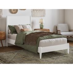 a white bed sitting on top of a wooden floor