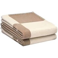 three towels stacked on top of each other in front of a white background with brown accents