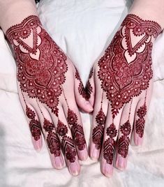 two hands with henna designs on them