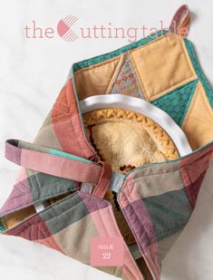 the inside of a quilted purse with a pie in it and text overlay that reads, the utting tale issue 29