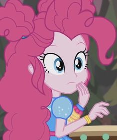 pinkie is sitting at a table with her hand on her face