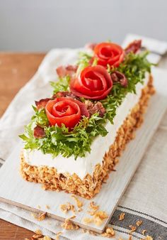 there is a piece of cake that has been decorated with tomatoes and lettuce