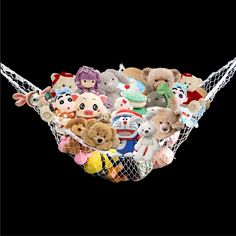 a bunch of stuffed animals are in a hammock on a black background,