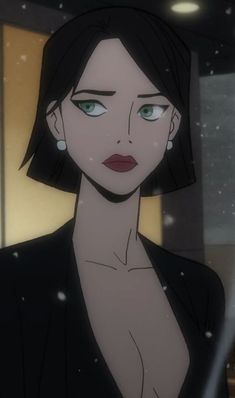 a woman with green eyes and black hair in a dark suit looking at the camera