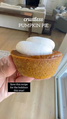 a person is holding a pumpkin pie with whipped cream on top and the caption reads crustless pumpkin pie save this recipe for the holidays this year