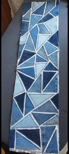 a blue table runner with white stitching on it