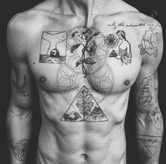 a shirtless man with tattoos on his chest