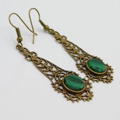 Long filigree earrings are a soft aged brass and have a green black glass stone at the bottom. These are so pretty and lightweight. The contrast of the brass and green is really nice. The earwires were missing so I did replace them. They are unmarked and in excellent condition. The drops alone measure 1 3/4 inch and from the top of the earwire to the bottom of the drop they are 2 1/4 inch. The kind of earring you find yourself reaching for all the time. Cute, dangly and comfortable. Find lots mo Elegant Green Copper Earrings, Green Brass Earrings As Gift, Green Brass Earrings For Gift, Victorian Green Drop Earrings, Ornate Green Earrings For Gift, Ornate Green Earrings As Gift, Pierced Green Copper Earrings, Green Copper Pierced Earrings, Green Filigree Teardrop Earrings