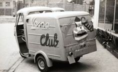 an old ice cream truck parked in front of a building