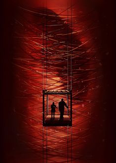 two people standing in a cage on top of a red background with long lines behind them