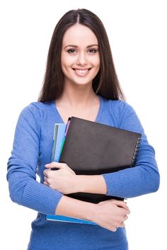 a woman is holding books and smiling at the camera with her arms folded around her