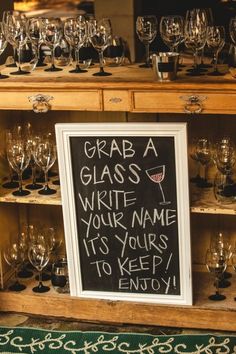 a sign that says grab a glass write your name it's yours to keep