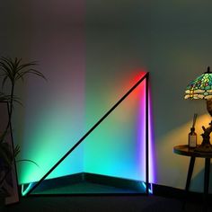 The Triangle Floor Lamp is an artistic, modern LED lamp that casts a stunning glow in one of eight pre-set colours. When you launch the dedicated app, you can choose a custom hue as well as 10 dynamic light modes to truly set the mood for any occasion. With the addition of the Music Sync mode, you can now create a true light show with a color-changing display that moves in time with the music or even your voice. Color: Black. Triangle Led Lights, Color Floor Lamp, Dynamic Light, Color Floor, Corner Lamp, The Triangle, Mood Light, Led Floor Lamp, Custom Lighting