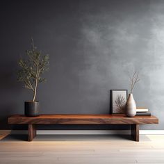 two vases sitting on top of a wooden table in front of a gray wall