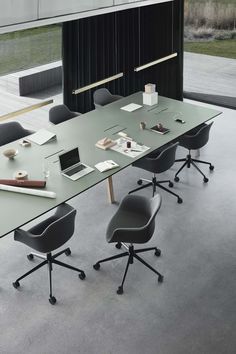 an empty conference table with chairs around it