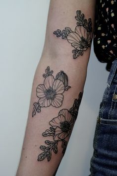 a black and white flower tattoo on the left arm, with an instagramt to follow