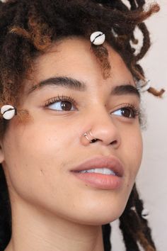 a close up of a person with dreadlocks on their head and one eye open